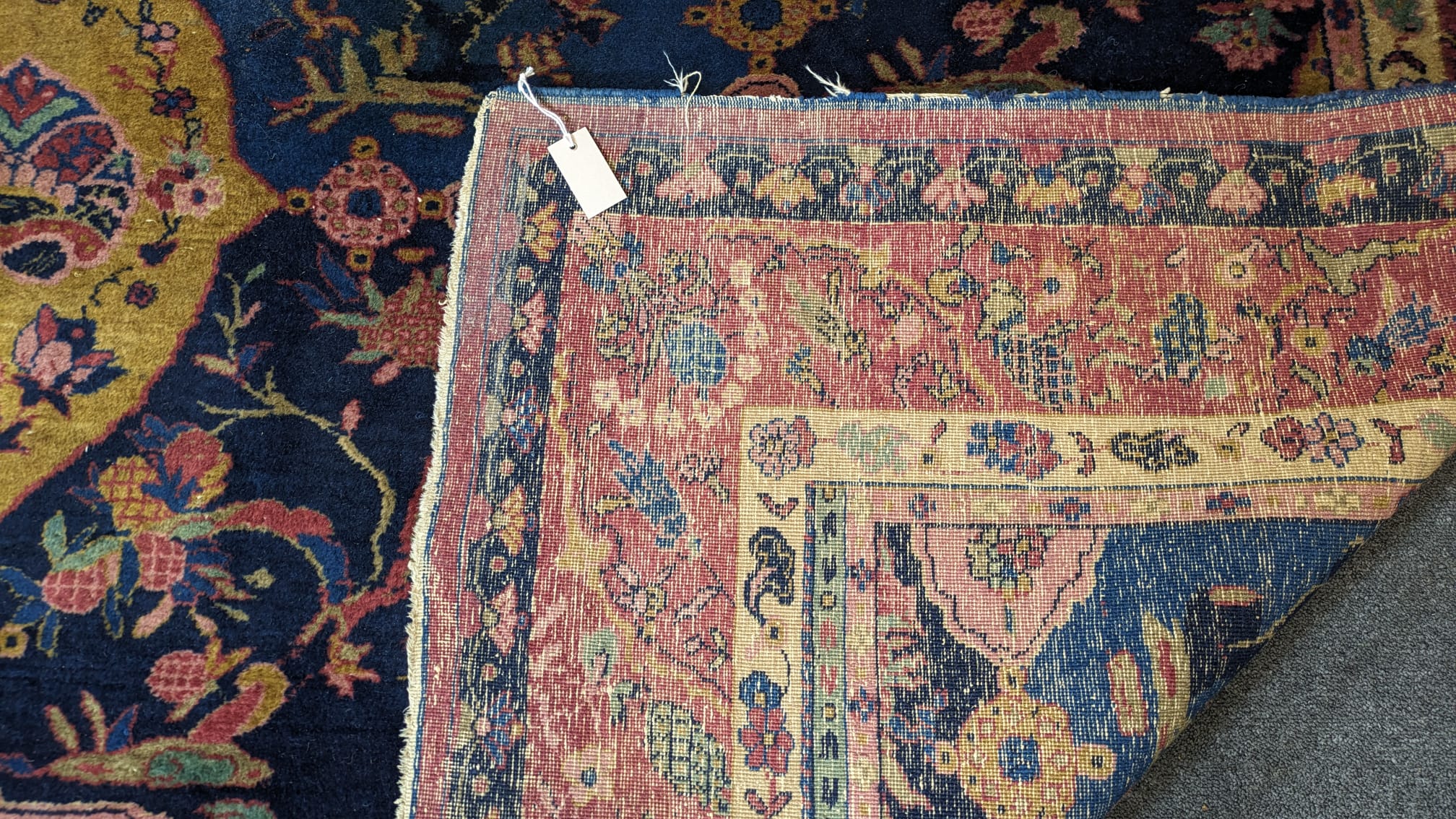 A Khorasan Mashhad red ground carpet, circa 1930’s, with field of stylised floral motif medallions, multi-bordered, 545 x 400cm. Condition - fair